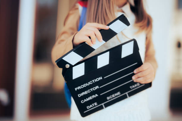 Little wannabe female director holding a film slate